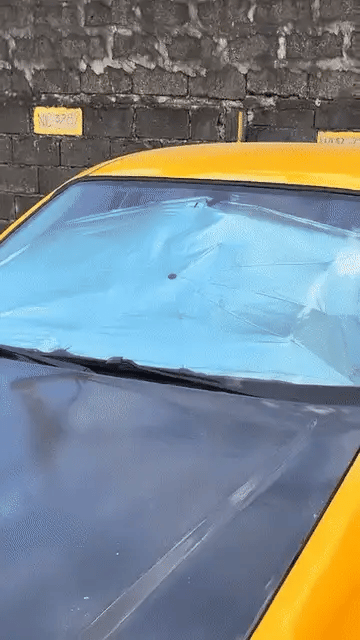 Portable Denx Car Umbrella by My Store shown in use, providing shade and protection for a vehicle in various weather conditions.