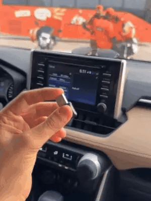 Wireless Car Play adapter by My Store, showing a sleek device connected in a car dashboard setup.